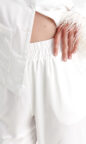 silky satin women's pajamas in ivory white with feather trim and pockets enhanced with piping, long sleeves and button up design