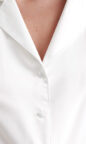 silky satin women's pyjamas in ivory white with feather trim and pockets enhanced with piping, long sleeves and button up design